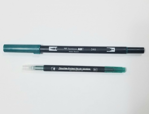 Two brush pens, one larger than the other.